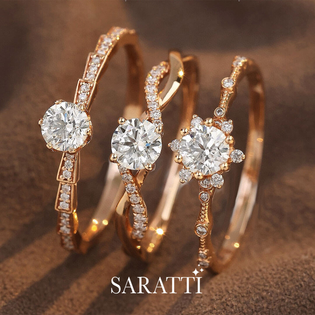 The Rose Gold Liaison Céleste Natural Diamond Engagement Ring in the centre among other rings | Saratti Diamonds 