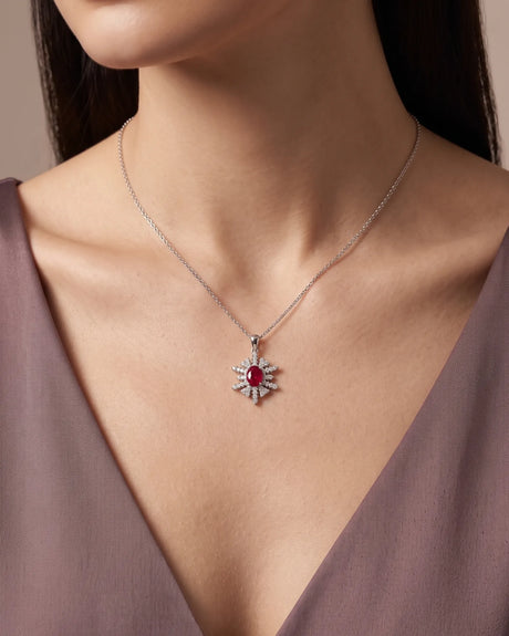 18K gold snowflake ruby pendant with oval red centre stone and branching diamond surround | SARATTI