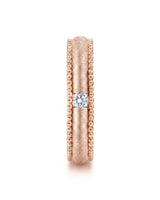 Round natural diamond wedding band framed by intricate textured craftsmanship in romantic 18K rose gold | SARATTI