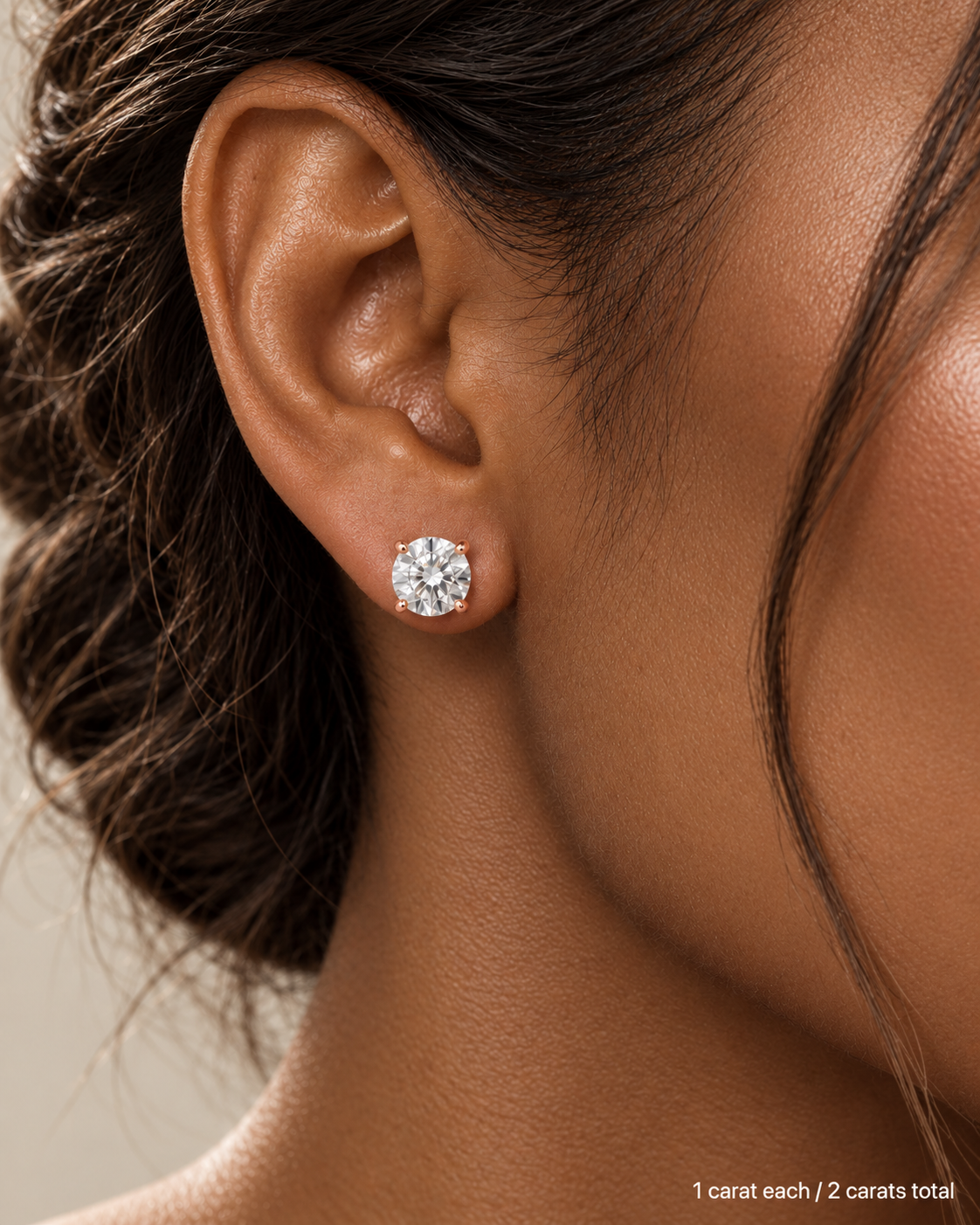 2.00 ct. tw. lab-grown round diamond studs in 18K rose gold, deep skin on-ear model | SARATTI