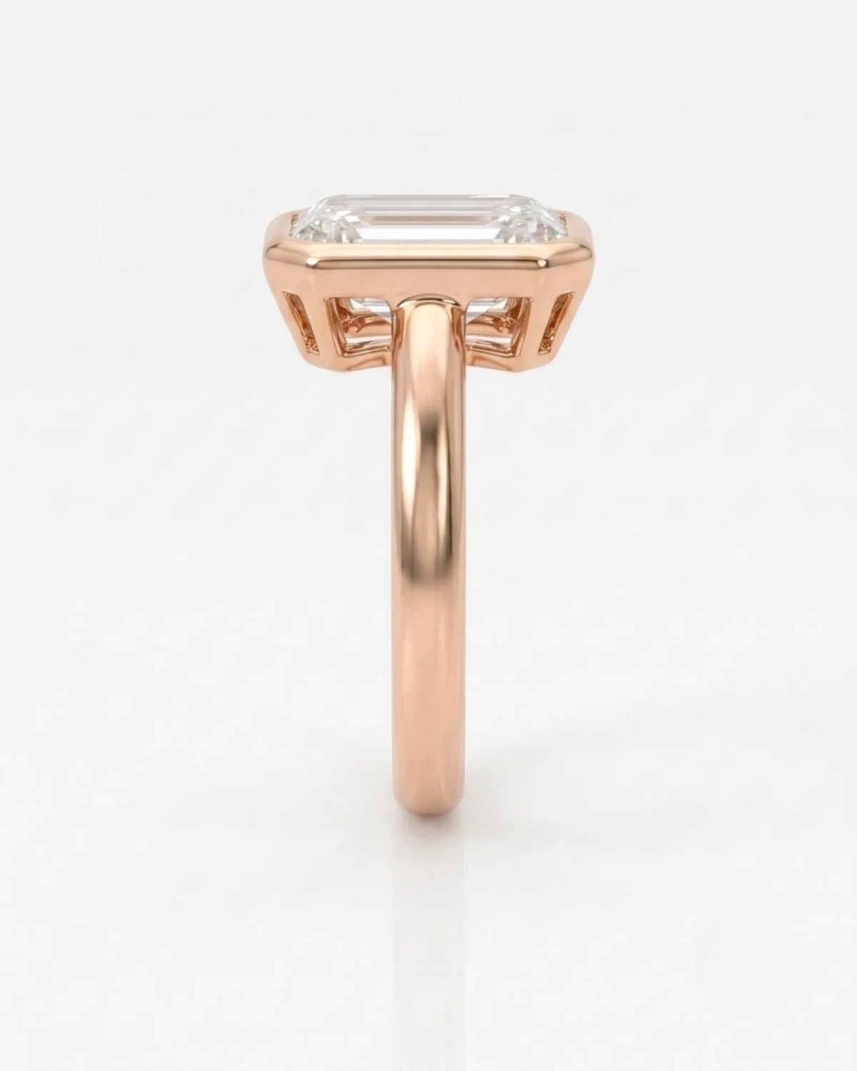 2 carat emerald-cut diamond bezel engagement ring in rose gold, side profile | SARATTI