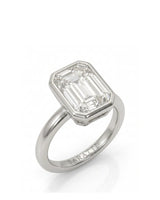 2 carat emerald-cut diamond bezel engagement ring in white gold, 45 degree | SARATTI