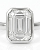 2 carat emerald-cut diamond bezel engagement ring in white gold, bezel detail | SARATTI