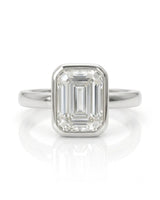 2 carat emerald-cut diamond bezel engagement ring in white gold, front | SARATTI