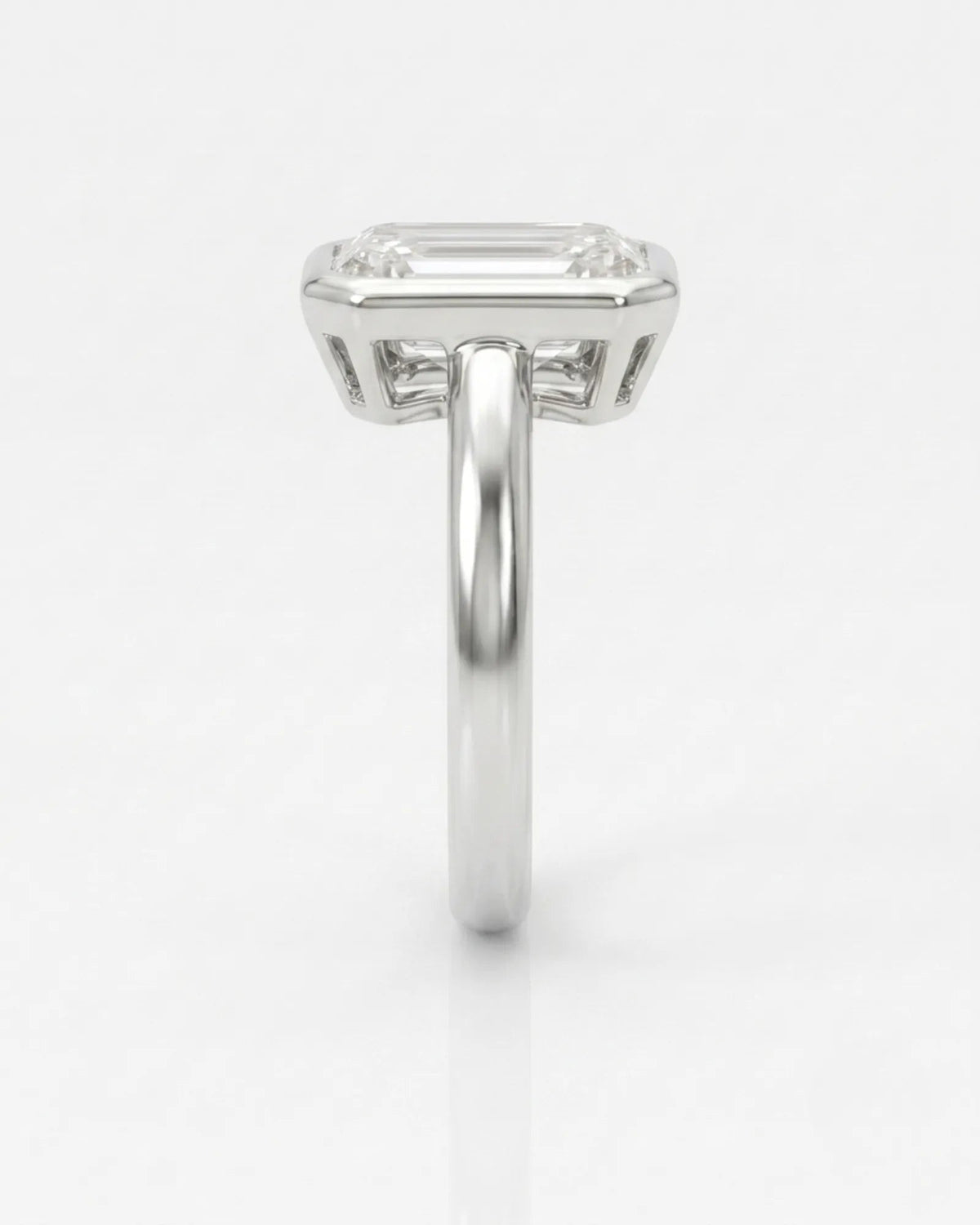 2 carat emerald-cut diamond bezel engagement ring in white gold, side profile | SARATTI