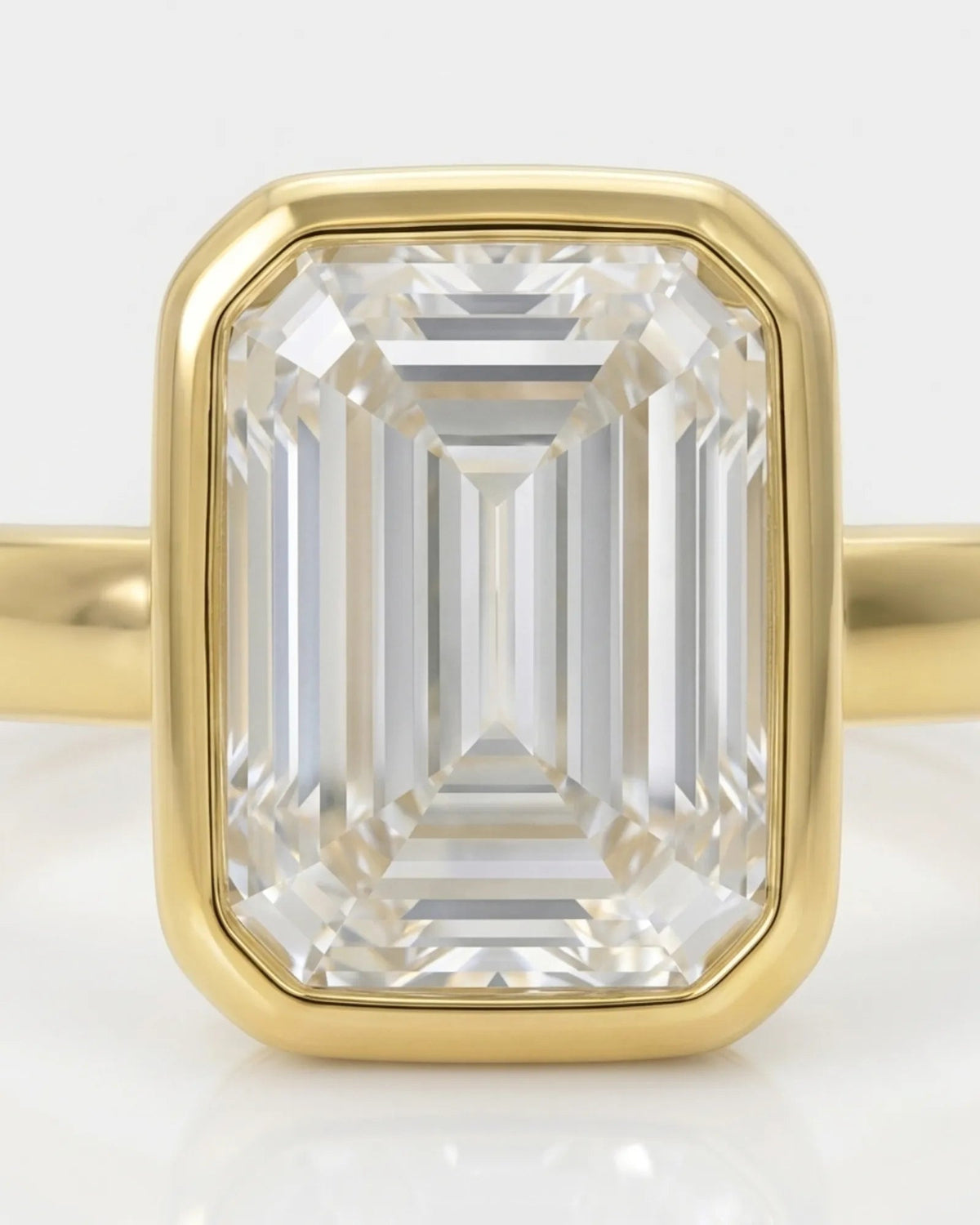 2 carat emerald-cut diamond bezel engagement ring in yellow gold, bezel detail | SARATTI