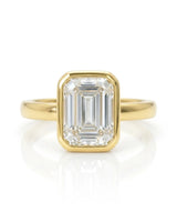 2 carat emerald-cut diamond bezel engagement ring in yellow gold, front | SARATTI