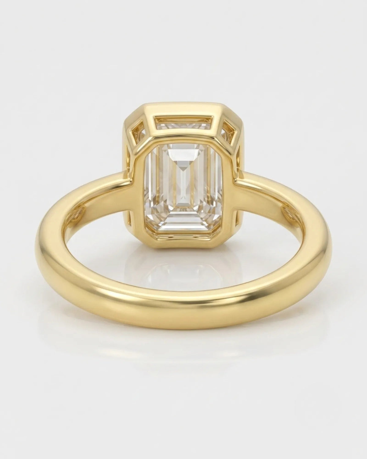 2 carat emerald-cut diamond bezel engagement ring in yellow gold, open gallery | SARATTI