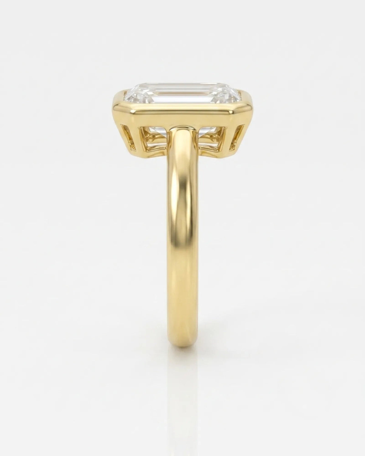 2 carat emerald-cut diamond bezel engagement ring in yellow gold, side profile | SARATTI