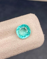 Close-up of 2.21ct Natural Green Emerald Cushion showing its Modified Brilliant facet arrangement | SARATTI