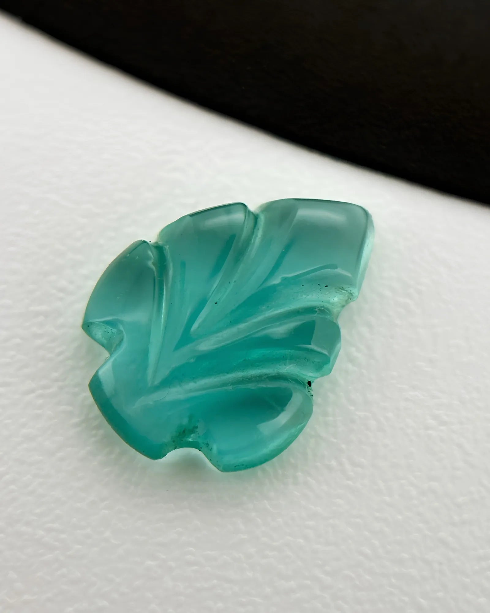 Natural Emerald carved leaf loose gemstones shown from an alternate angle | SARATTI