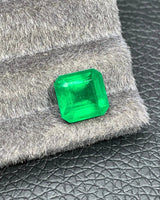 4.95 CTS Vivid Green Natural Emerald from an alternate angle, showing its octagonal outline and step facets | SARATTI