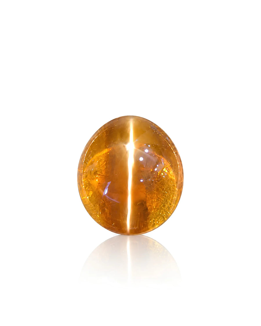 5.00 carat natural Brown Cat's-Eye Chrysoberyl oval cabochon held in tweezers with a bright chatoyant band under directional light