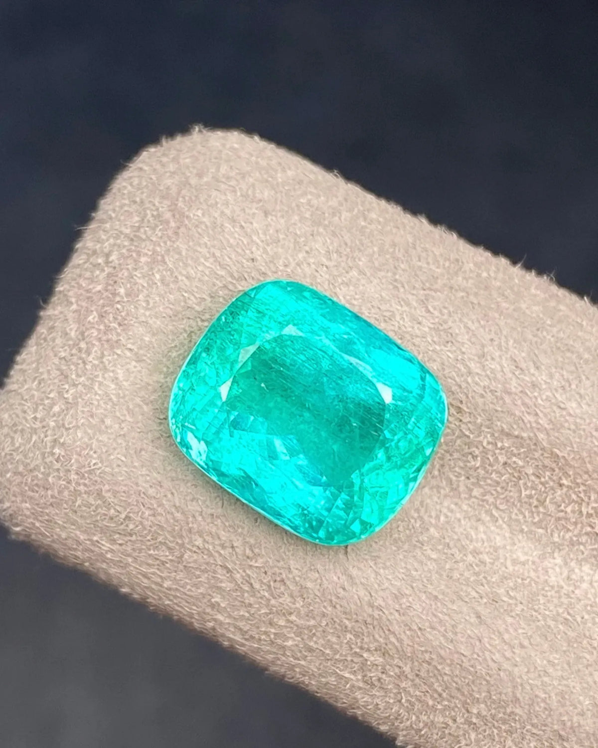 Close-up of 5.01ct Natural Intense Green Emerald Cushion showing Modified Brilliant facet reflections | SARATTI