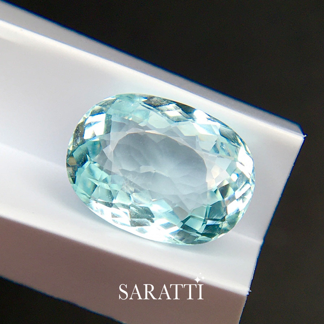 5.05 carat neon light blue tourmaline oval cut faceted loose gemstone macro | SARATTI