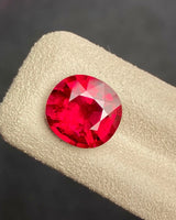 Natural pinkish red Rubellite Tourmaline oval loose gemstone in an alternate face-up view | SARATTI