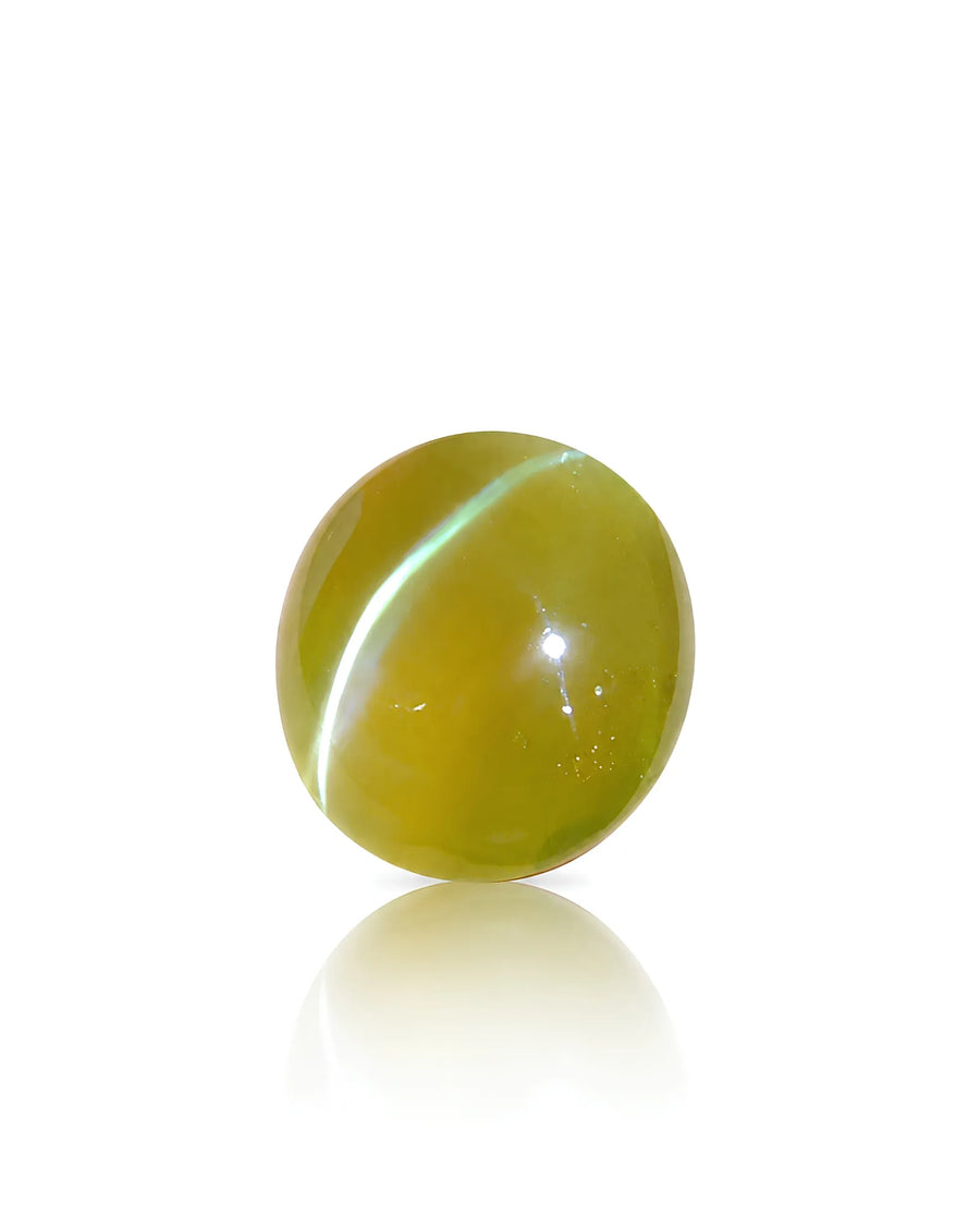 7.37 carat natural Honey Color Cat's-Eye Chrysoberyl oval cabochon showing a bright chatoyant band on the hand