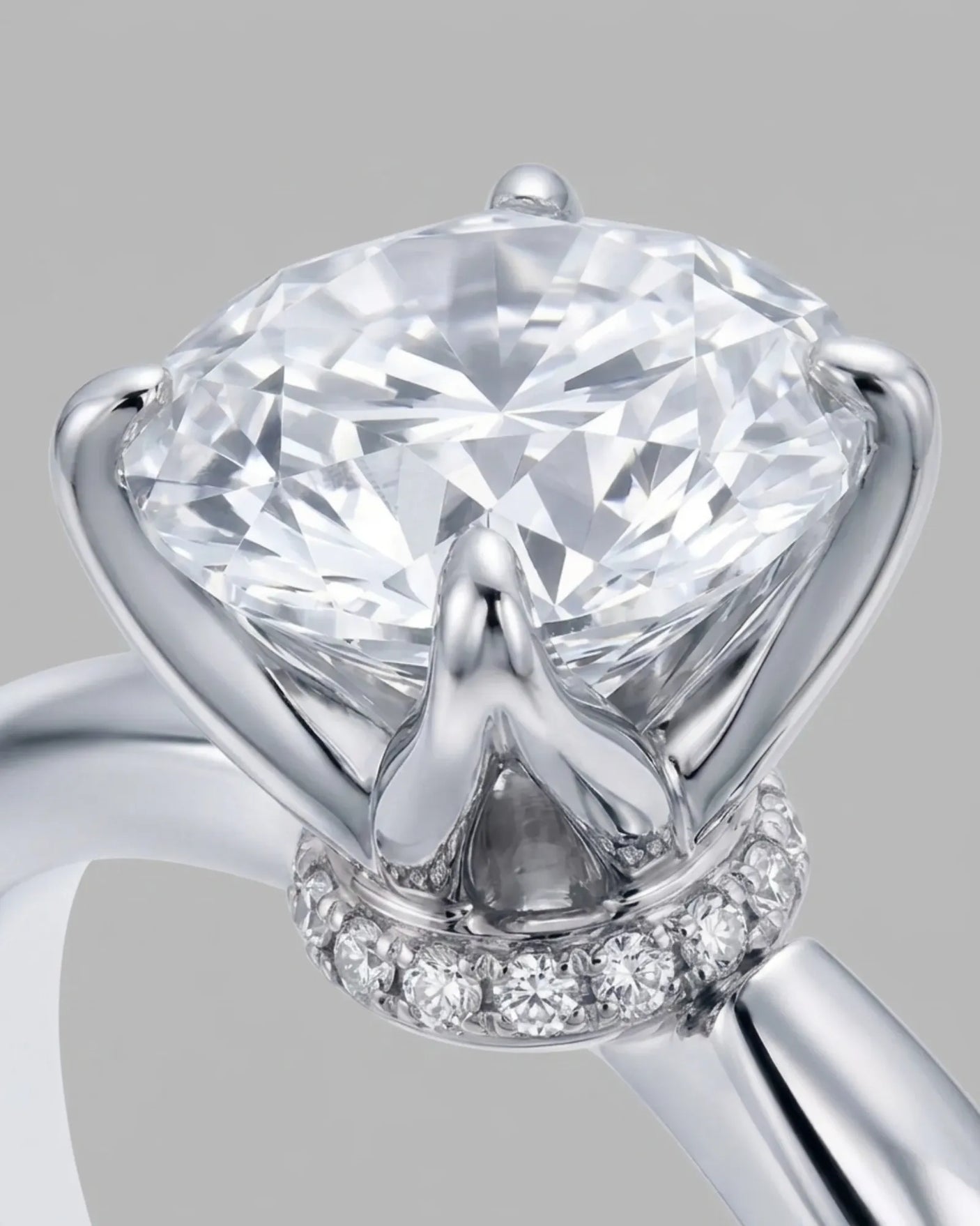 D color round moissanite center with discreet pavé accents in enduring 18K white gold | SARATTI
