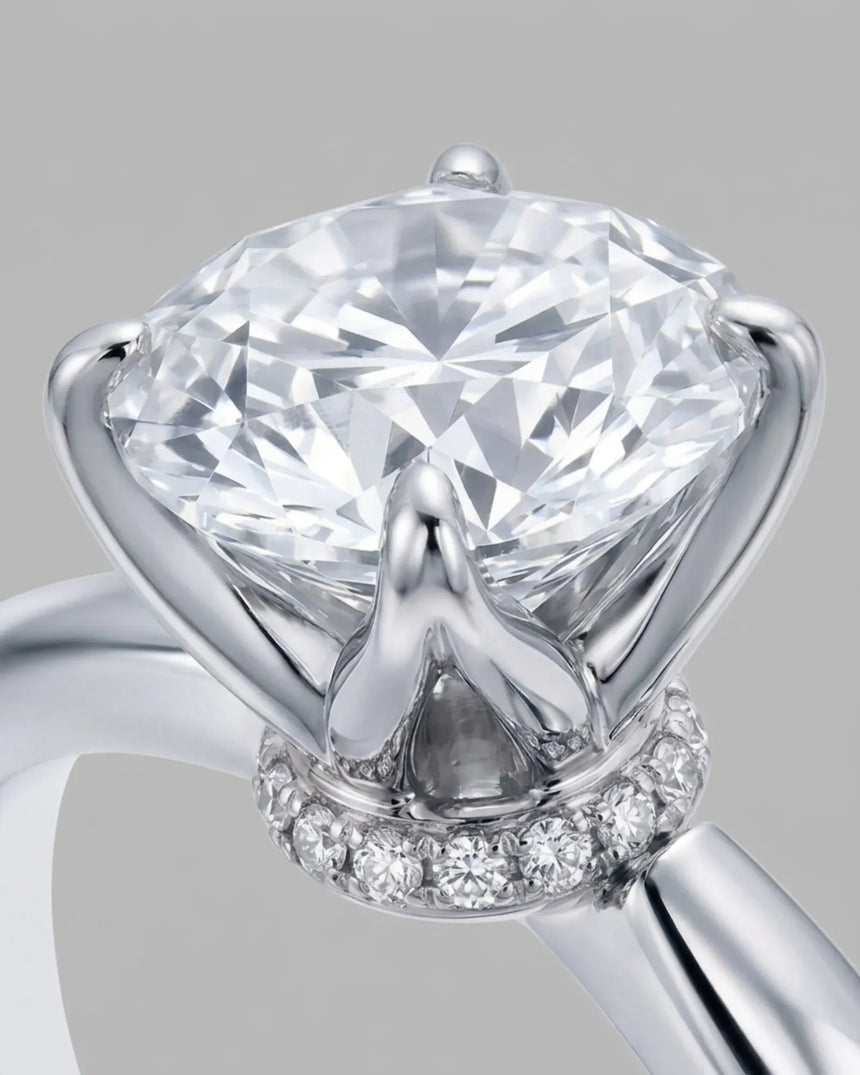 D color round moissanite center with discreet pavé accents in enduring 18K white gold | SARATTI
