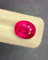 Natural pinkish red Rubellite Tourmaline oval loose gemstone in alternate face-up view | SARATTI
