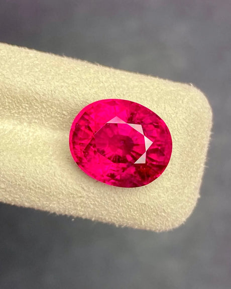 Natural pinkish red Rubellite Tourmaline oval loose gemstone in alternate face-up view | SARATTI