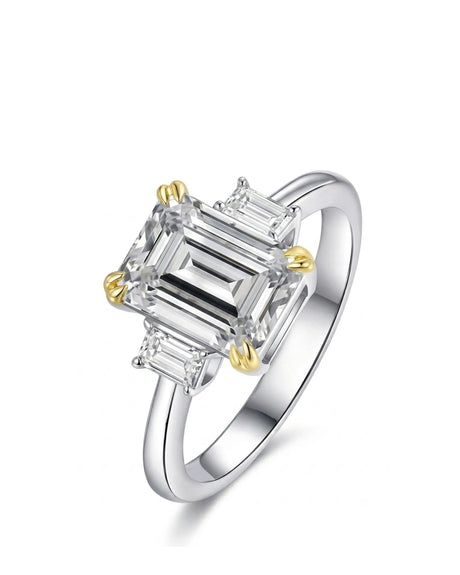 Alma emerald-cut diamond three-stone engagement ring with step-cut side diamonds in two tone | SARATTI