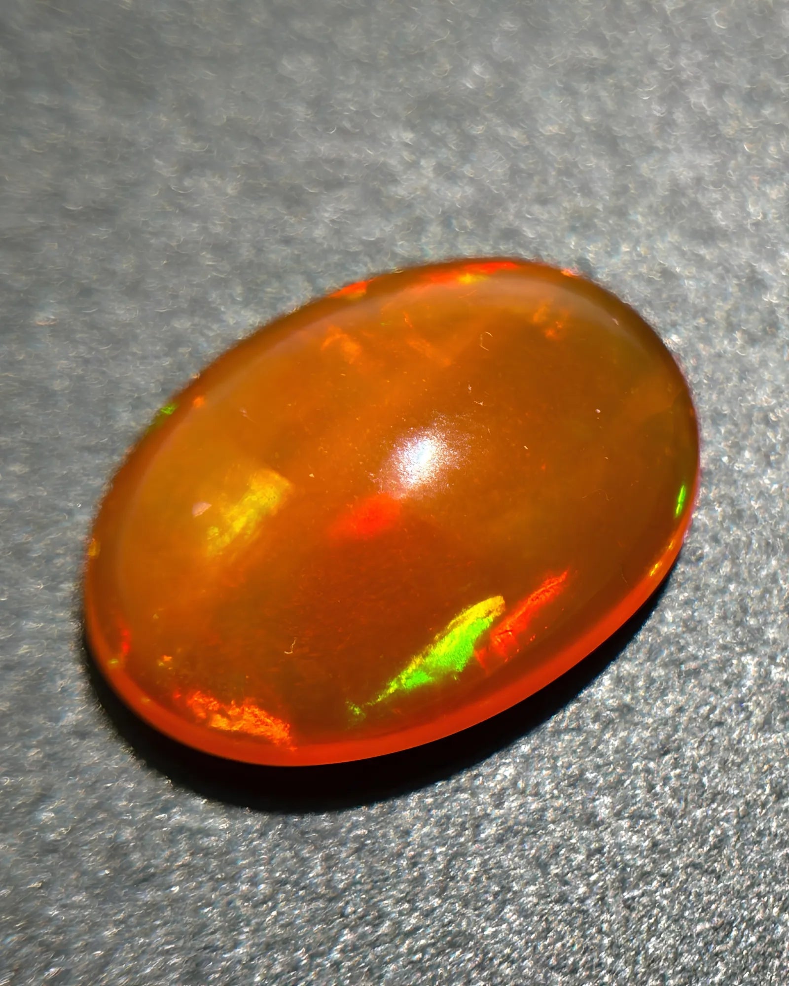Alternate angle of orange Fire Opal with red yellow and green play-of-colour | SARATTI