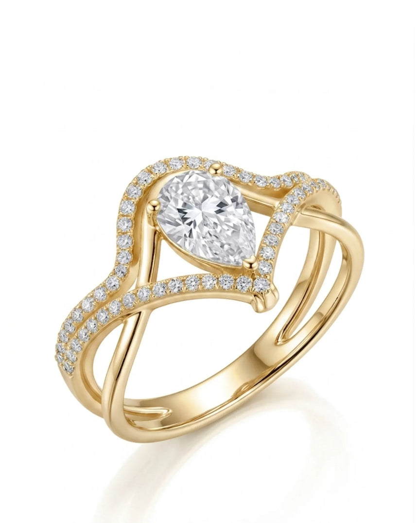 Amara pear-cut moissanite bridal set with flowing bands and round accents in 18K yellow gold | SARATTI