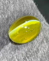 Angled view of 2.02 carat Natural vivid yellow Cat's Eye Chrysoberyl cabochon | SARATTI