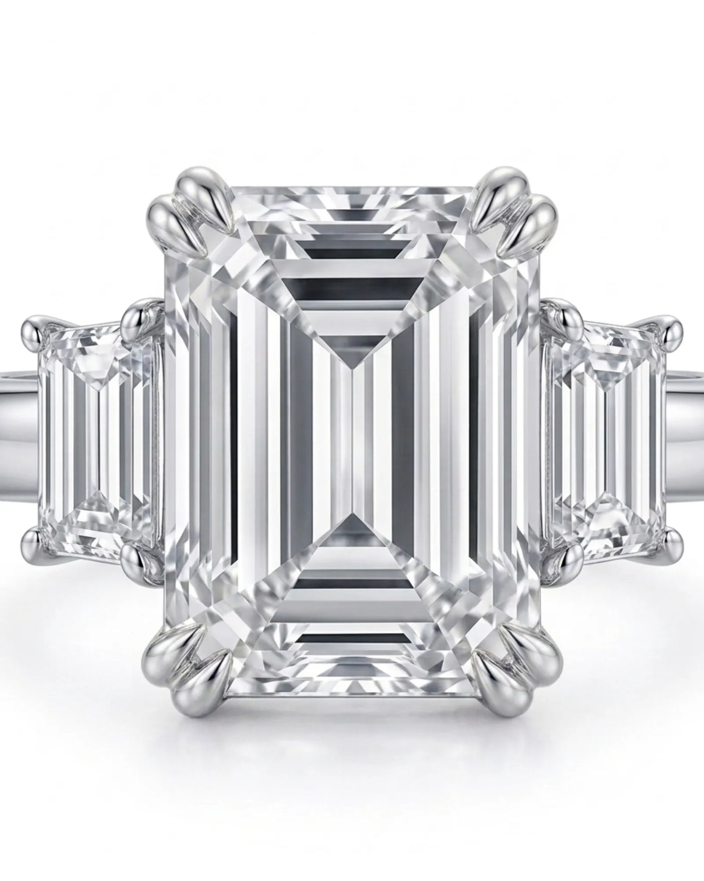 Architectural emerald-cut diamond ring with balanced side stones and a refined platinum band | SARATTI