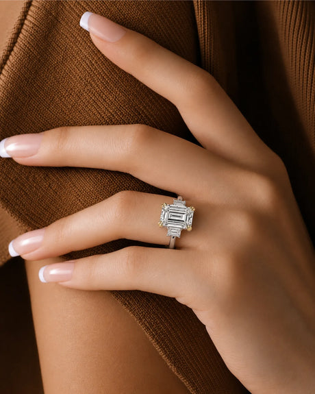 Architectural emerald-cut diamond ring with balanced side stones and polished 18K white gold band with yellow band | SARATTI