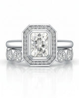 Art Deco moissanite engagement ring with stepped geometric halo and round accents in 18K white gold | SARATTI