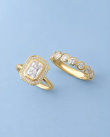 Art Deco moissanite engagement ring with stepped geometric halo and round accents in 18K yellow gold | SARATTI