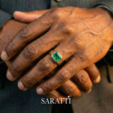 Mens emerald wedding ring emerald cut center stone detail in 18K white gold | SARATTI