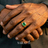 Mens emerald wedding ring emerald cut center stone detail in 18K yellow gold | SARATTI