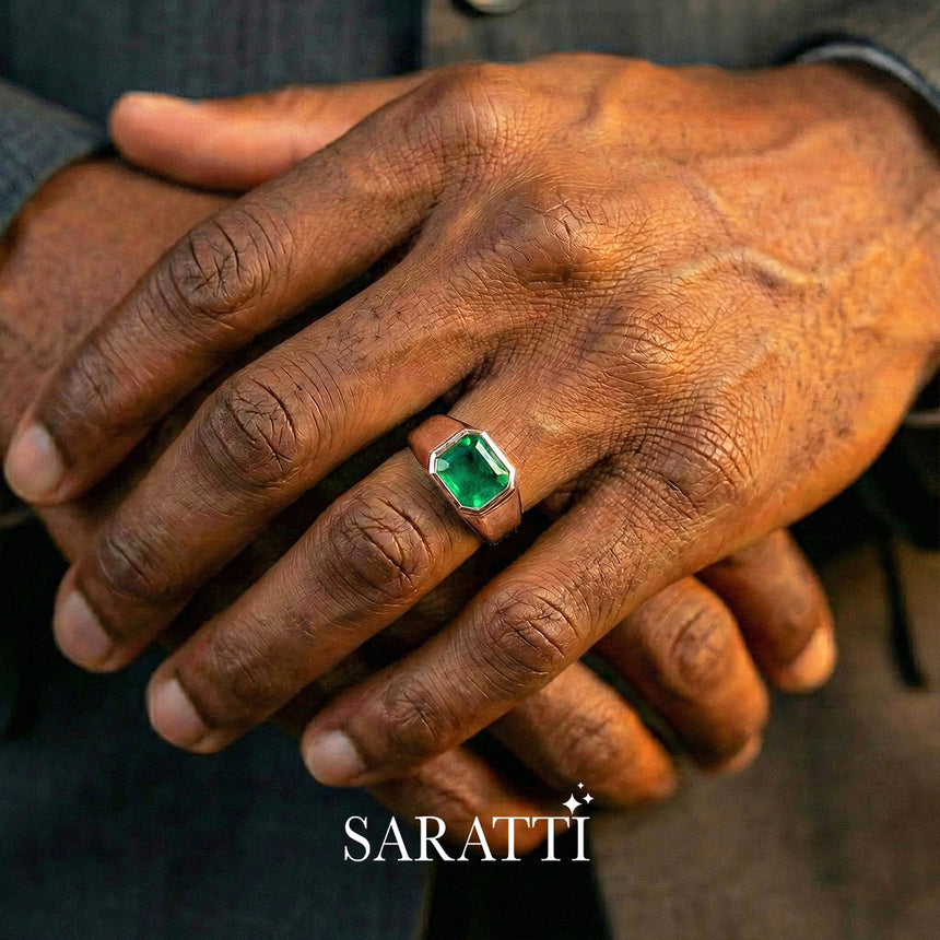 Mens emerald wedding ring emerald cut center stone detail in 18K rose gold | SARATTI