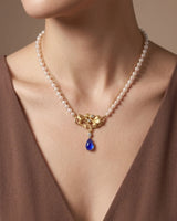 Artistic tanzanite pendant necklace with botanical gold centrepiece, pearl strands and diamond accents | SARATTI
