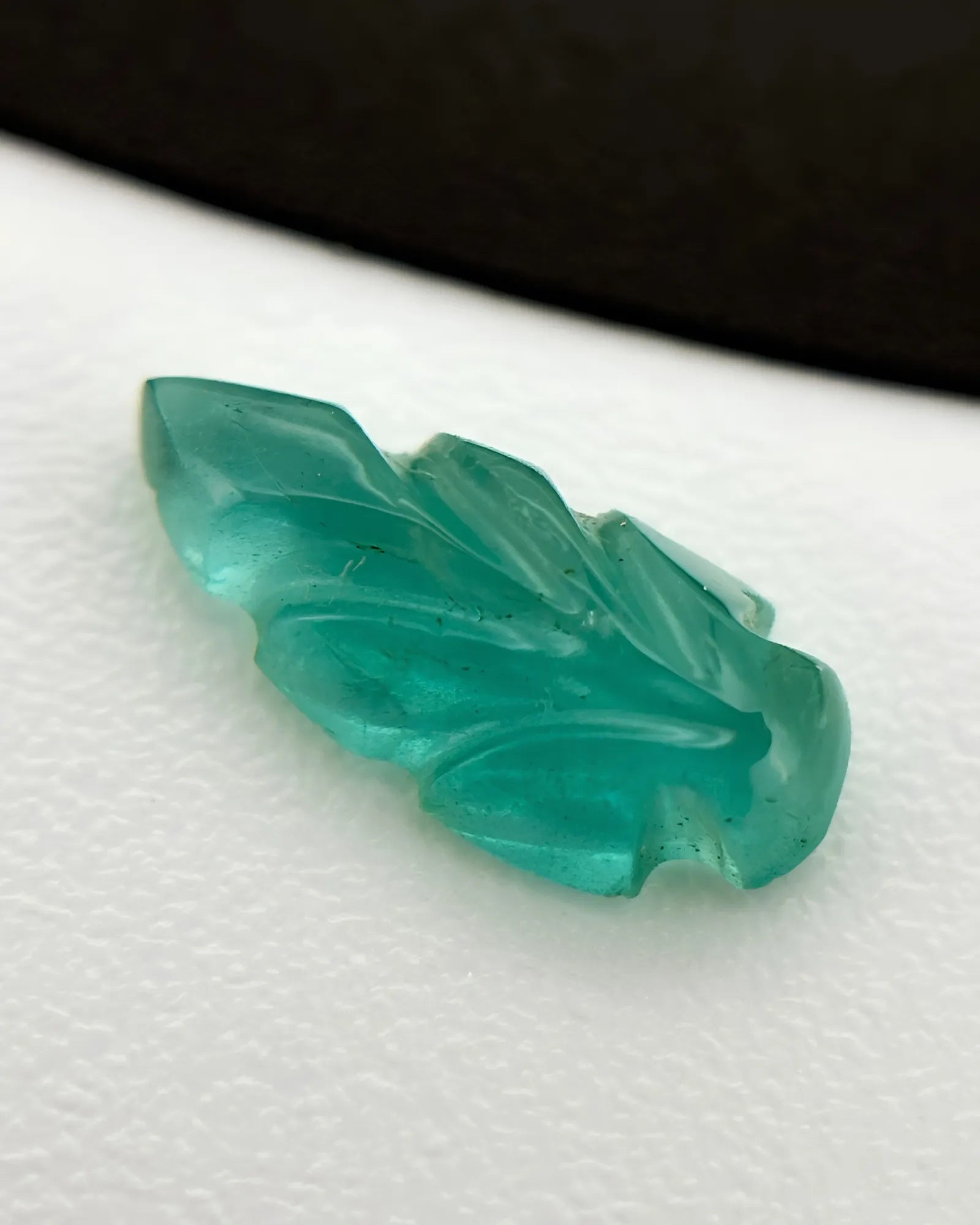 Back view of 0.63ct Natural Emerald carved leaf gemstone | SARATTI