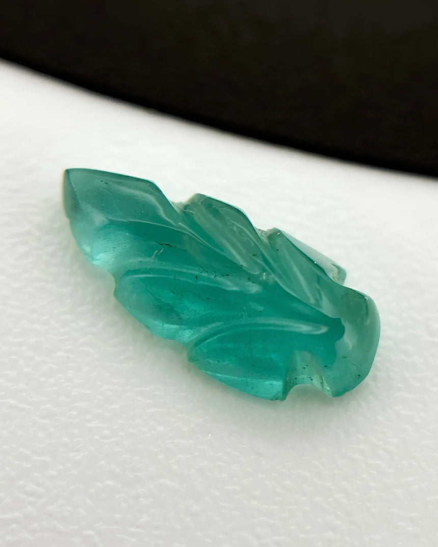 Back view of 0.63ct Natural Emerald carved leaf gemstone | SARATTI