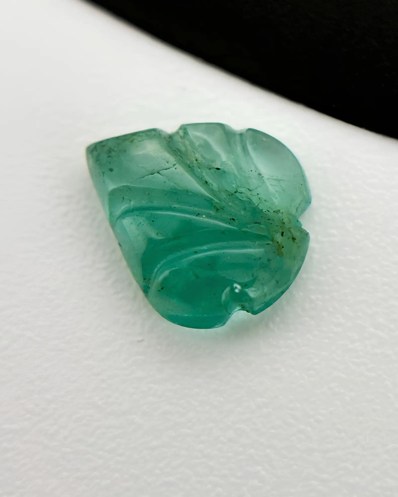 Back view of 0.74ct Natural Emerald carved leaf gemstone | SARATTI