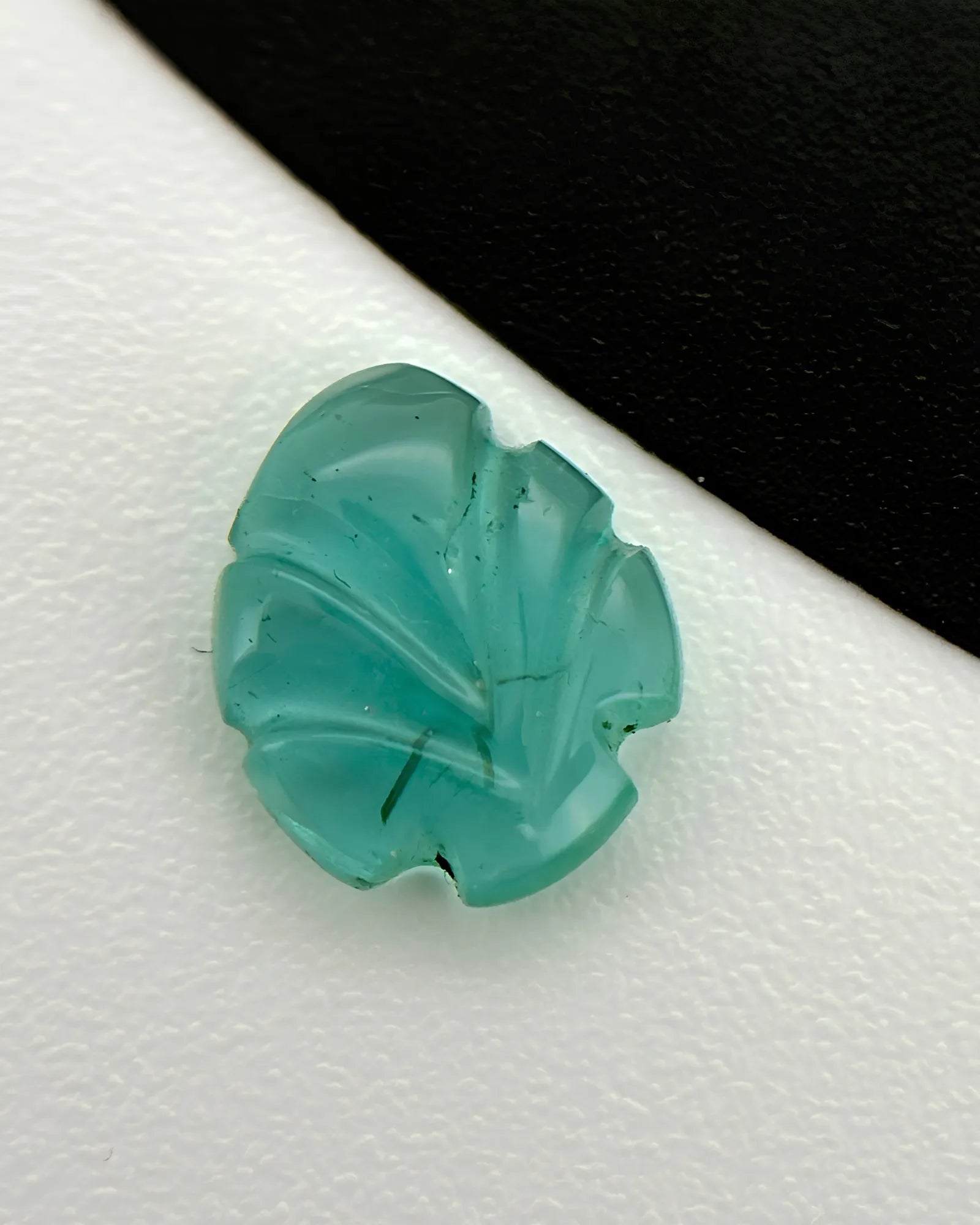 Back view of 0.79ct Natural Emerald carved leaf gemstone | SARATTI