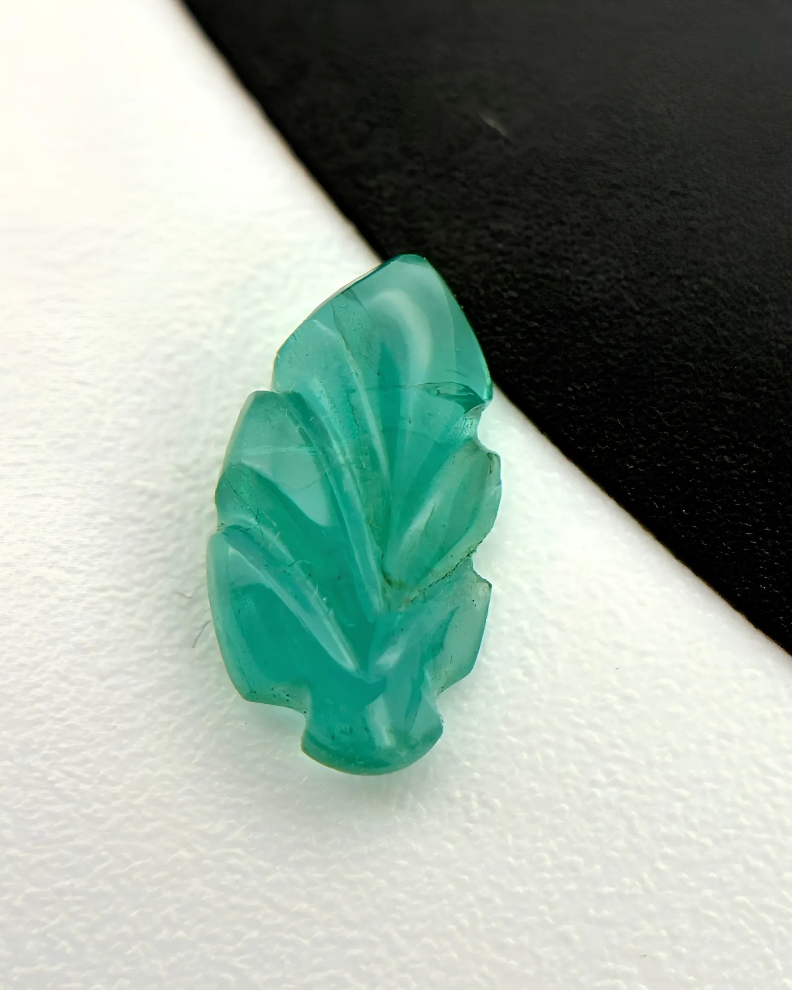 Back view of 0.87ct Natural Emerald carved leaf gemstone | SARATTI