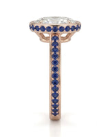 Bezel-set oval moissanite ring with sapphire gallery accents and slim 18K rose gold shank | SARATTI