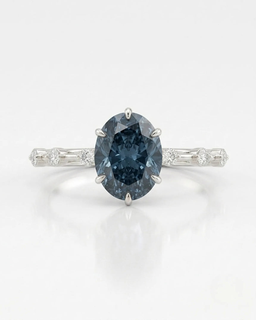 Blue moissanite ring with sculptural prong setting and refined white gold band | SARATTI