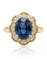 Blue oval sapphire ring with round natural diamonds in 18K yellow gold | SARATTI