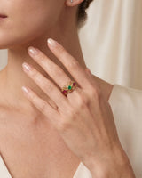 Butterfly filigree ring with lace-like gold wings, emerald centre and ruby-set shoulders in 18K gold | SARATTI