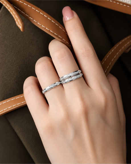 Classic 18K white gold wedding bands featuring sleek channel settings and a refined half-eternity diamond design | SARATTI