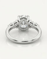 Classic five stone moissanite ring with oval center and sculptural prongs in platinum | SARATTI
