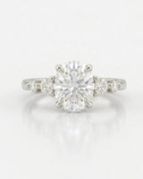 Classic five stone moissanite ring with oval center and sculptural prongs in white gold | SARATTI
