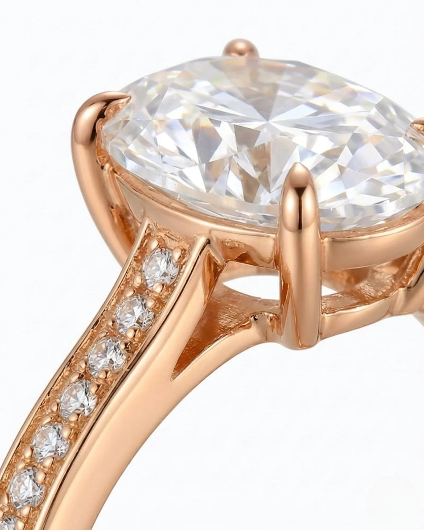 Classic oval moissanite ring with four prong setting and pavé band in rose gold | SARATTI